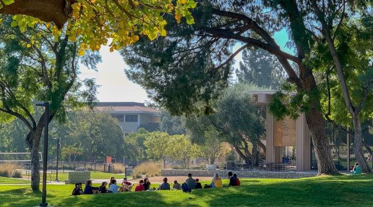 Students have class on The Mounds facing McConnell Center