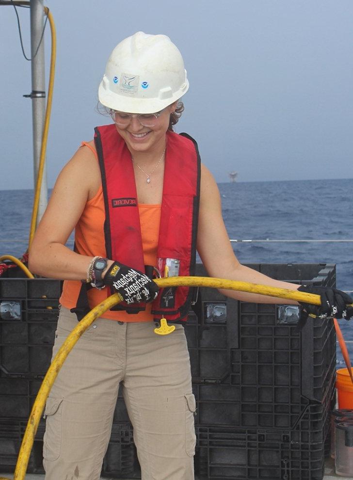 emma saso works on a boat during her research project